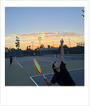Playing tennis at sunset